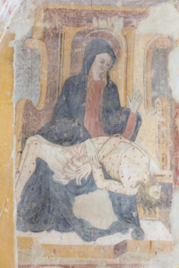 Affresco della Pietà con Madonna in abito scuro che sorregge Cristo morto ferito e decorazioni sullo sfondo.